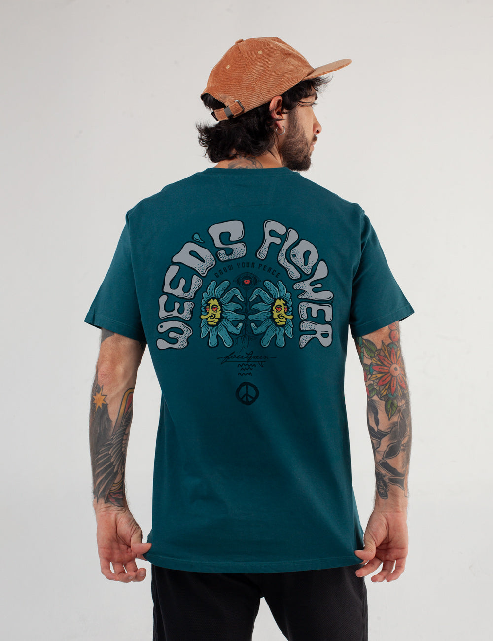 wearing a dark teal FOU Store t-shirt